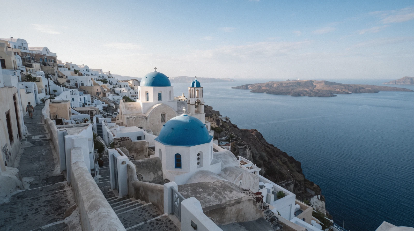 Two blue-domed churches stacked on the caldera edge in Oia at 07:30, santorini blue domes, Santorini Greece