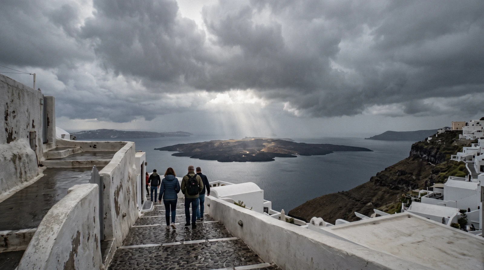 Heavy grey clouds breaking over the caldera at Fira on an autumn afternoon, santorini weather, Santorini Greece