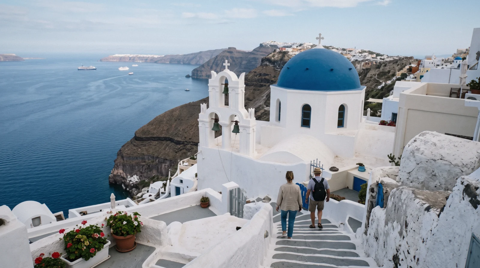 The blue-domed Catholic church with three bells on the caldera slope at Firostefani at 08:00, three bells of fira, Santorini Greece
