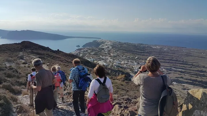 Hikers on the caldera path between Imerovigli and Oia on a guided Fira to Oia hike, Santorini Greece