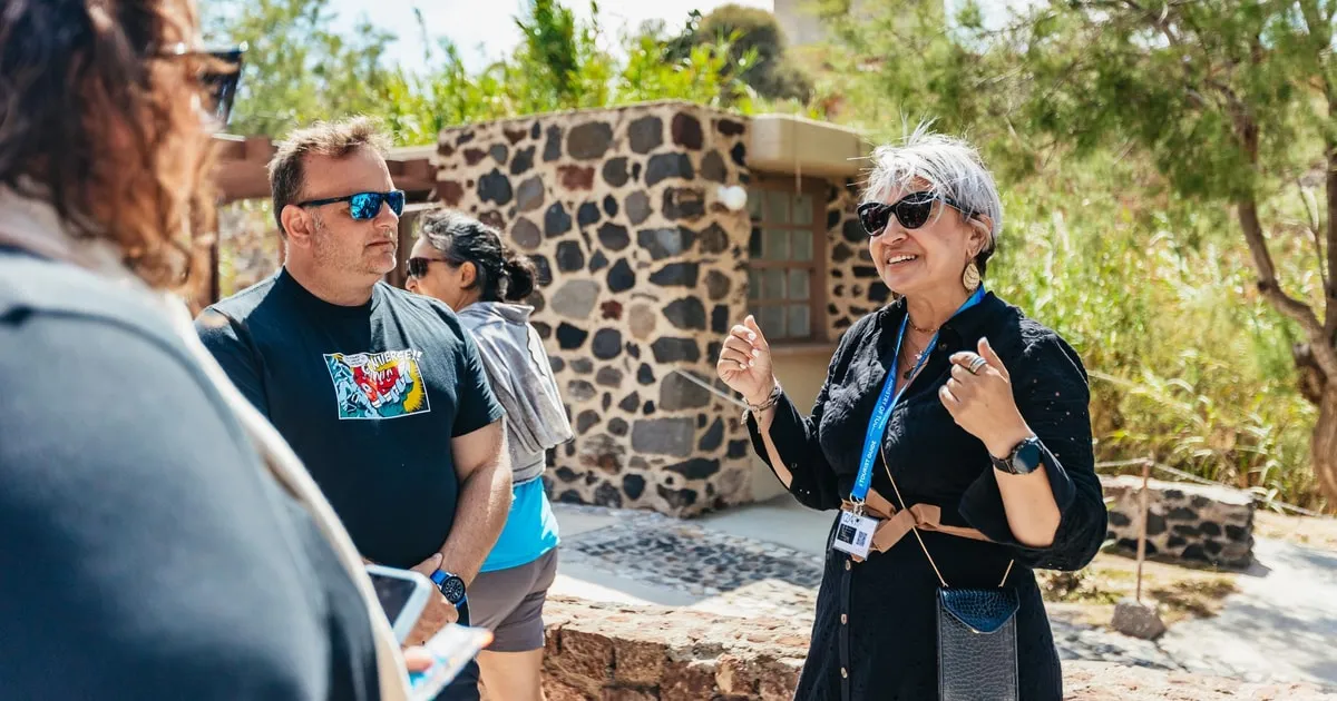 Licensed guide inside the roofed Akrotiri excavation on a private tour, Santorini Greece