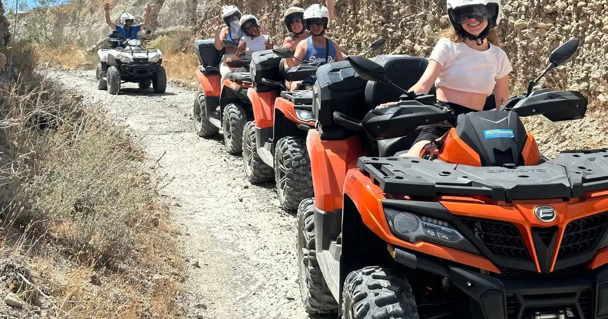 ATVs above the red cliffs on a guided off-road safari, Santorini Greece