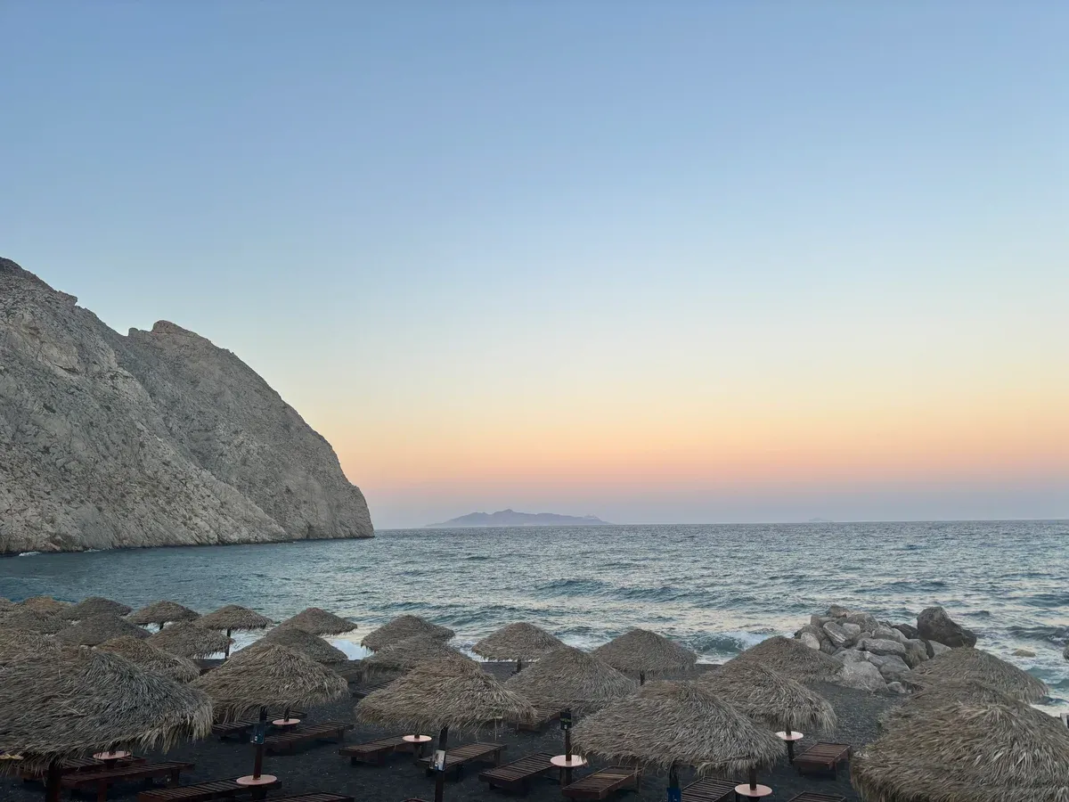 Perissa beach and Mesa Vouno, the ridge of Ancient Thera, at sunset, Santorini Greece